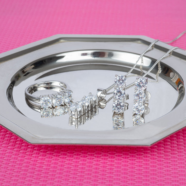 Trilogy set placed on the plate that stand on a table covered with a pink tablecloth. 