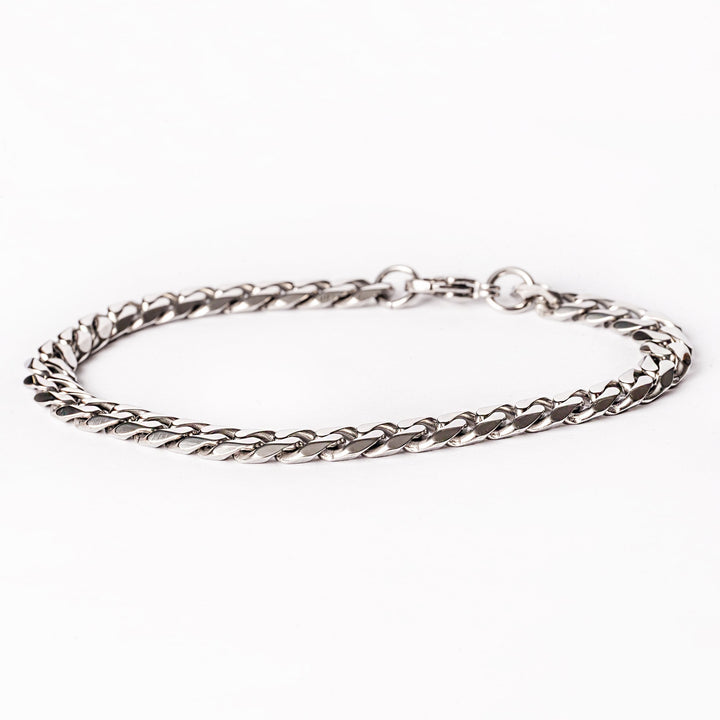 A silver stainless steel bracelet with a jewelry clasp, displayed on a white background.