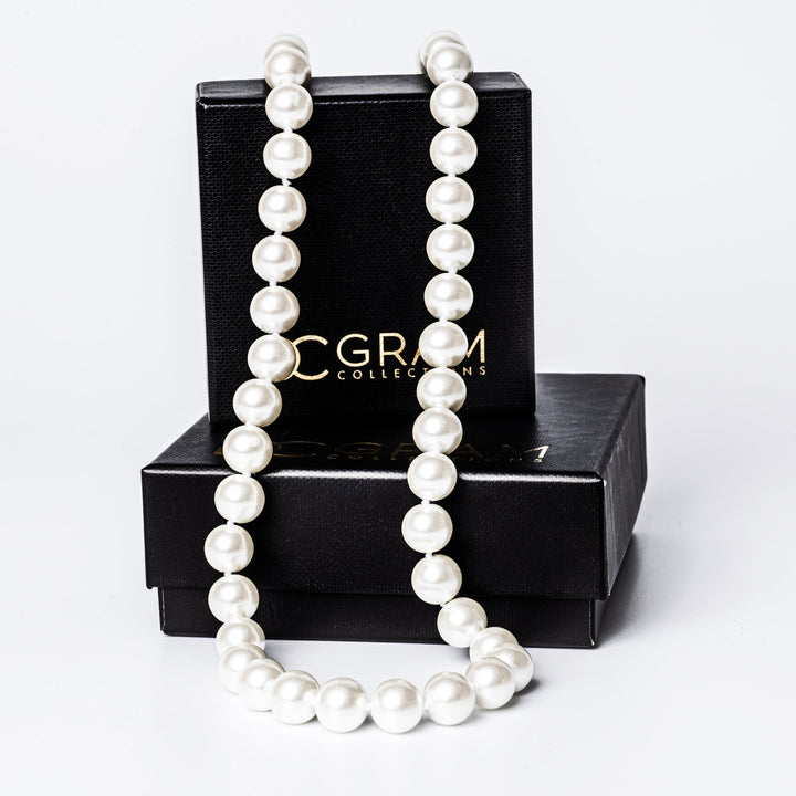 A twilight necklace placed on its box, surrounded by a white background. 