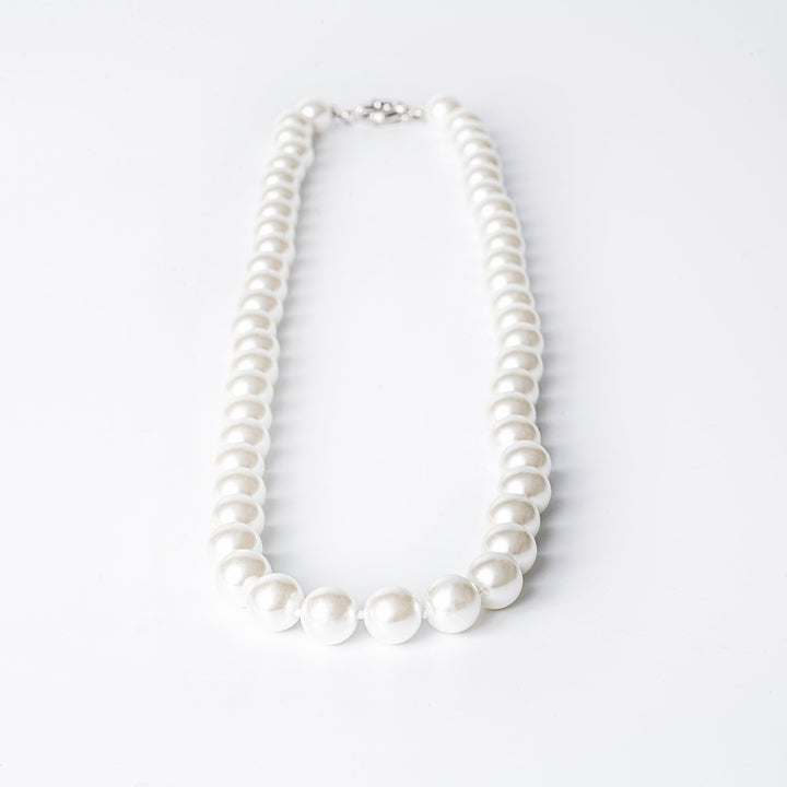 A silver-colored pearl  Twilight necklace with a clasp closure, displayed against a white background.