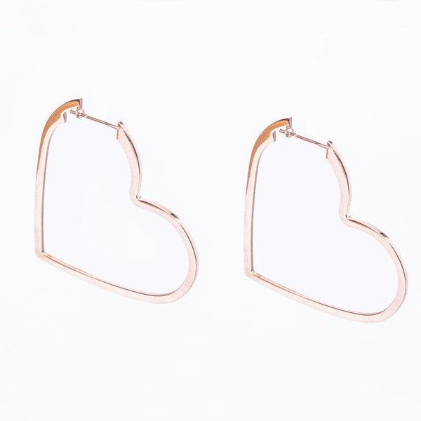A pair of rose gold-colored heart-shaped hoop earrings on a white background