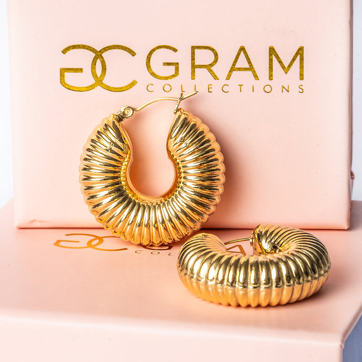 A gram collections Valerie Earrings placed on its uniquely designed box. 