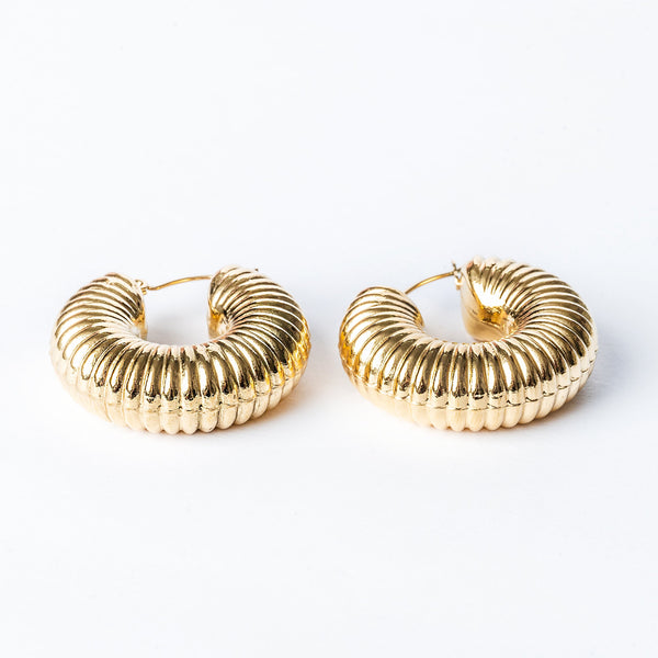 A pair of yellow gold hoop Valerie earrings with a textured surface on a white background.