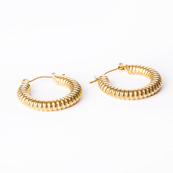 A gold vivi earrings standing in the center of the image against a white background. 