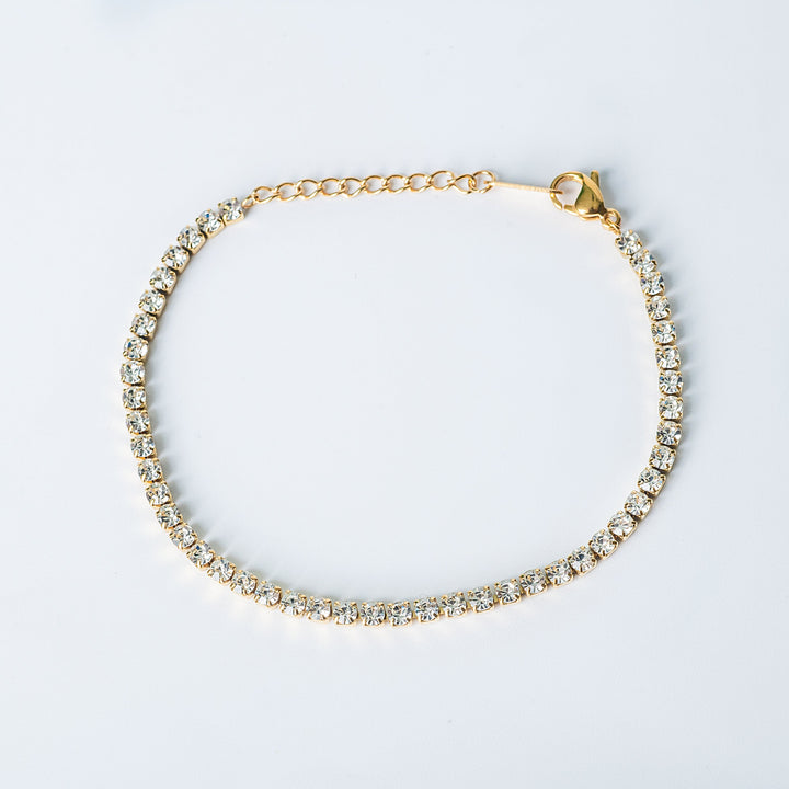 Gold Vegas tennis bracelet with clear stones photographed from a top view