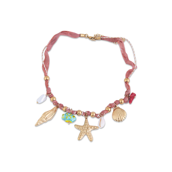 Wied Il-Ghasri Necklace with shell, starfish, and beach ball charms on a pink cord against a white background