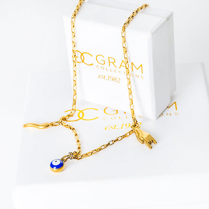 Xorti necklace with a blue evil eye charm on a white background with 'G. Gram' branding.