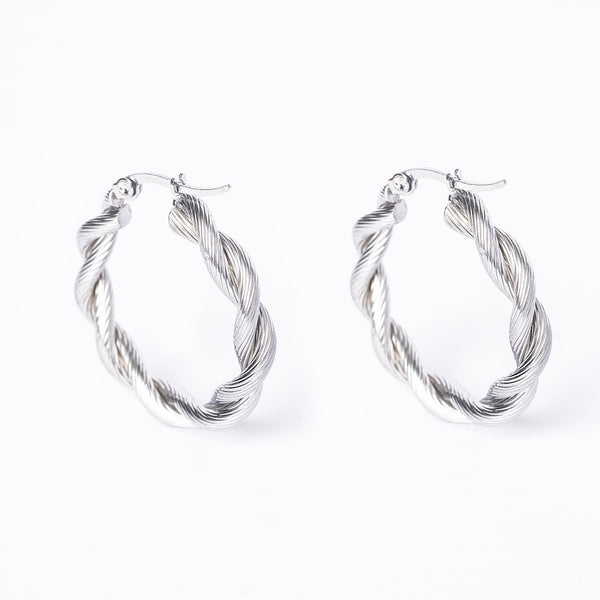A pair of silver Yanica hoop earrings on a white background