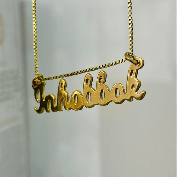 A gold-colored Inhobbok (handwritten) Necklace with a personalized pendant that reads 'Inhobbok', displayed against a white background.