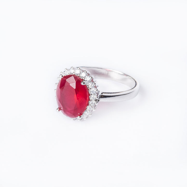 lefts side view of Kate Ring standing in the center of the image against a white background. 