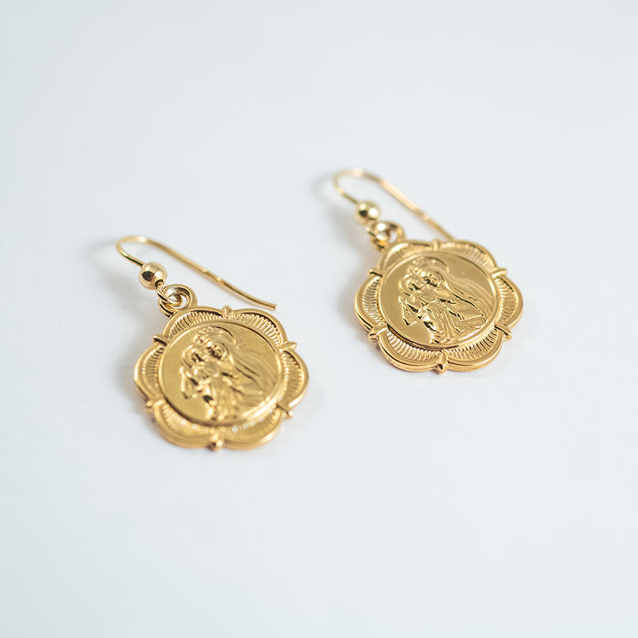 A close up view of Santo Gold standing in the center of the image against a white background. 
