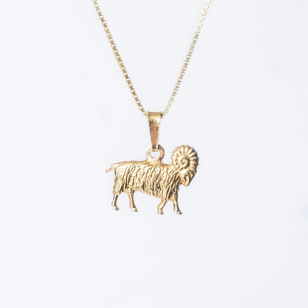 A gold-plated sterling silver Airies  necklace with a ram design on a chain.