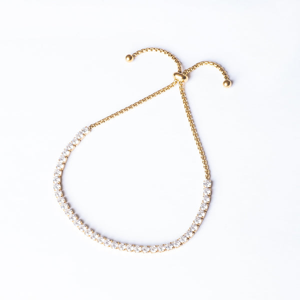 A yellow gold-plated stainless steel bracelet featuring a series of round AAA cubic zirconia gemstones.