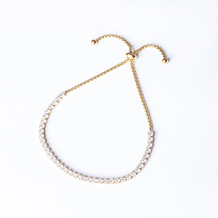 A yellow gold-plated stainless steel bracelet featuring a series of round AAA cubic zirconia gemstones.