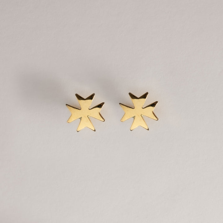 A birdview of Malta Cross Gold Stud standing in the center of the image against a white background. 