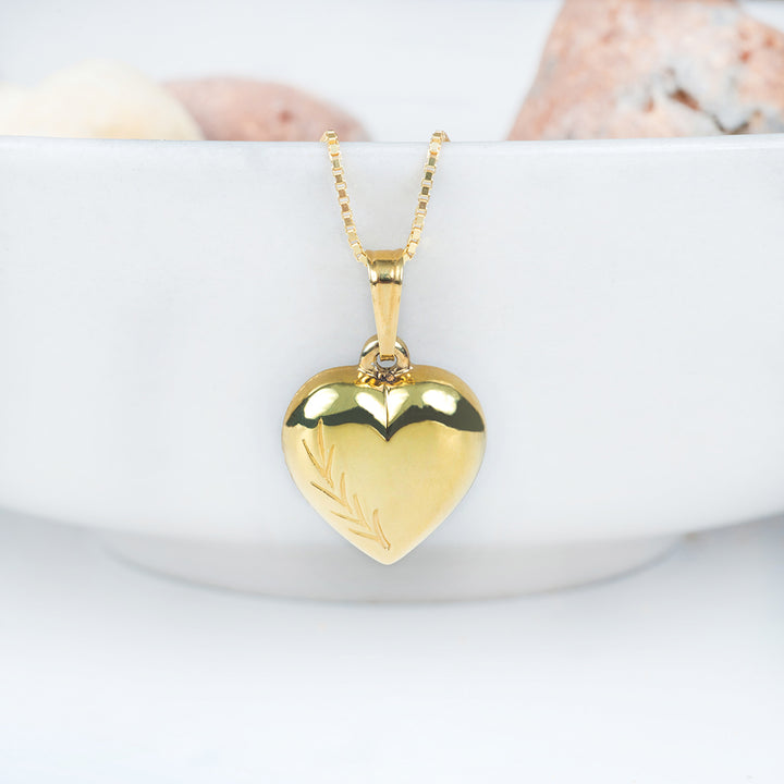 Bliss Heart Gold Pendant standing in the center of the image