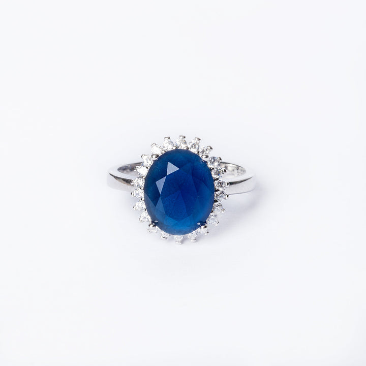 A close up view of blue colour Kate Ring standing in the center of the image against a white background. 
