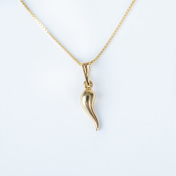 A yellow gold-plated sterling silver Bzaru Lucky Charm Pendant in the shape of a curved arrow, displayed against a white background.