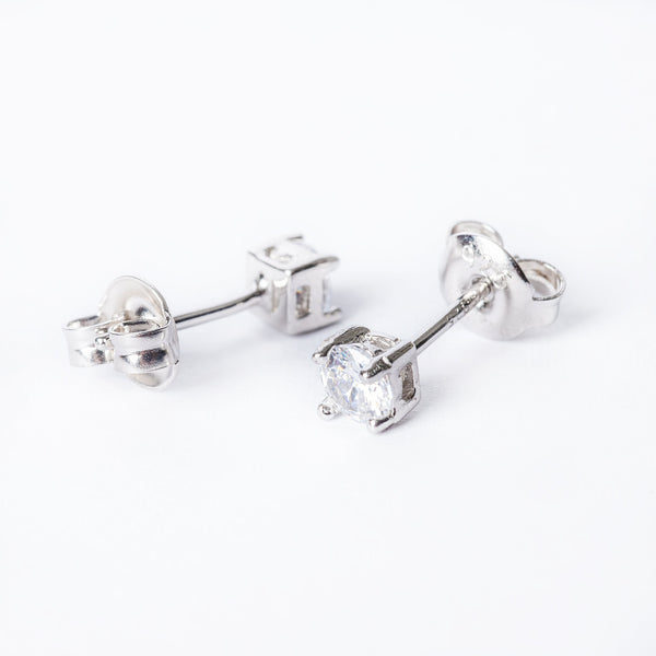 A pair of silver solitaire earrings with a cubic zirconia gemstone