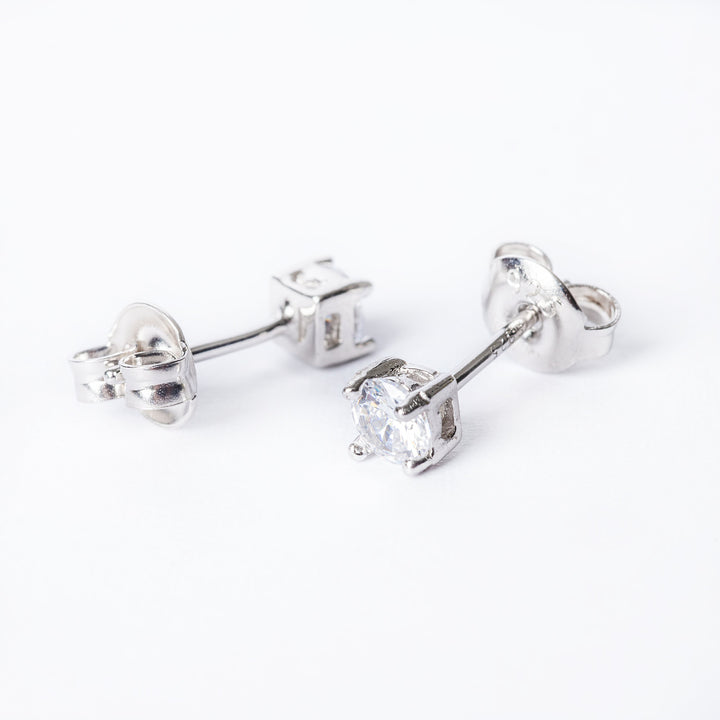 A pair of silver solitaire earrings with a cubic zirconia gemstone