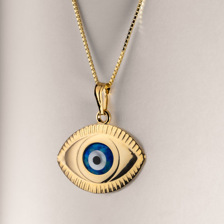 A close up view of evil eye pendant. 