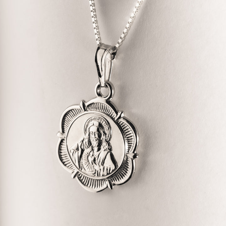 A close up view of Silver Holy Medal Double Sided Pendant. 