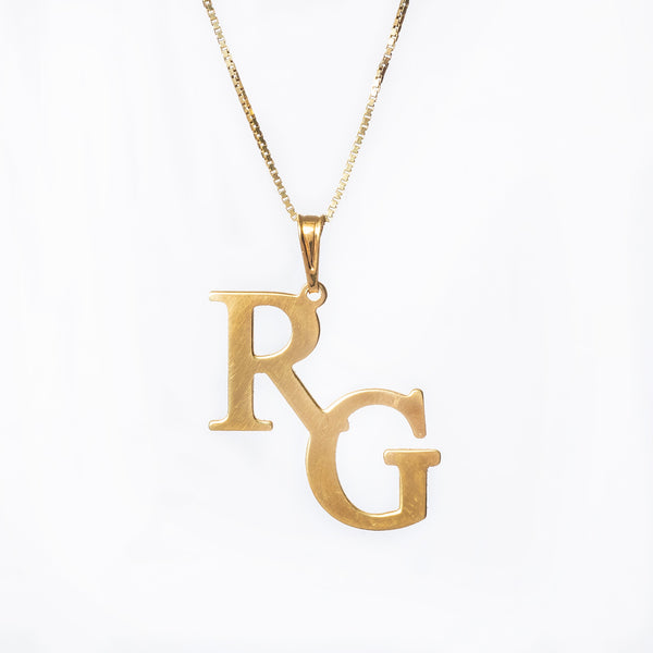 A gold Double initial necklace with the double initial pendant 'RG' attached to a chain.