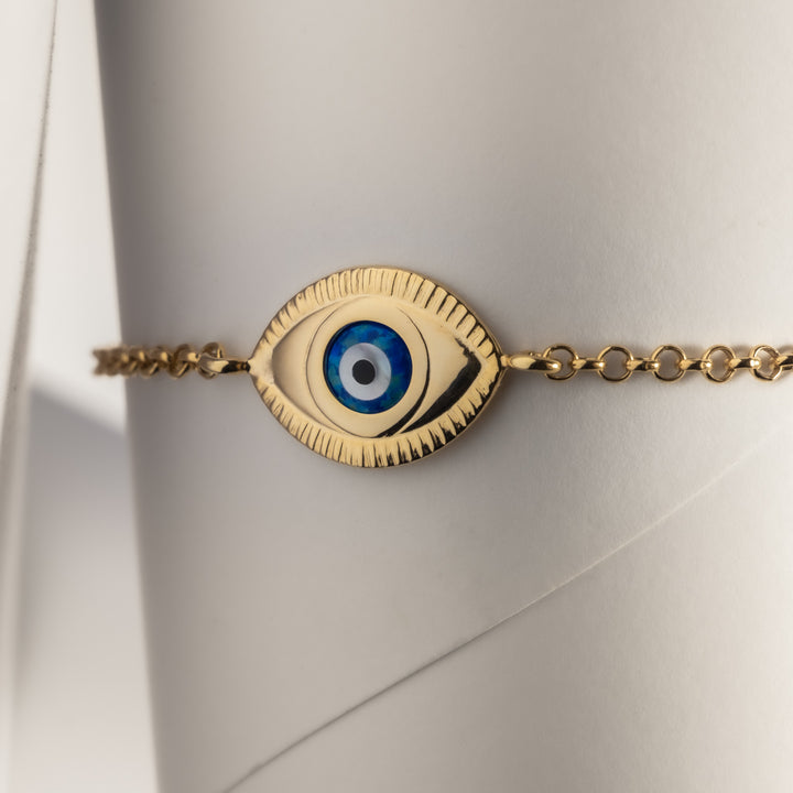 A close up view of Evil Eye Gold Bracelet standing in the center of the image against a white background. 