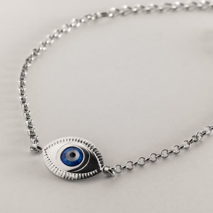 A close up view of Evil Eye Silver Bracelet standing in the center of the image against a transparent background. 