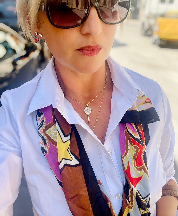 Woman wearing Il-Muftieh Necklace in combination with her white shirt. 