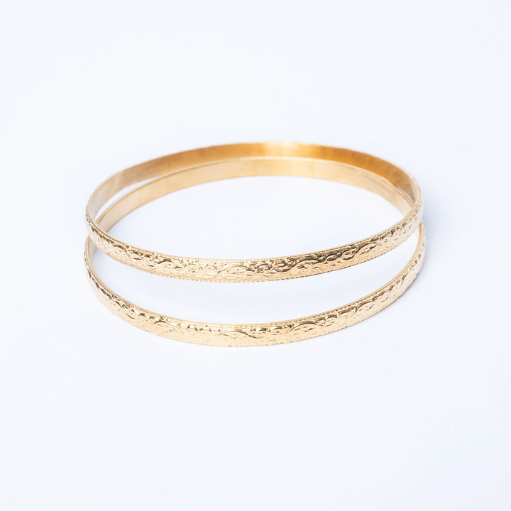 Fili Designed Bangles close up view standing in the center of the image against a white background.