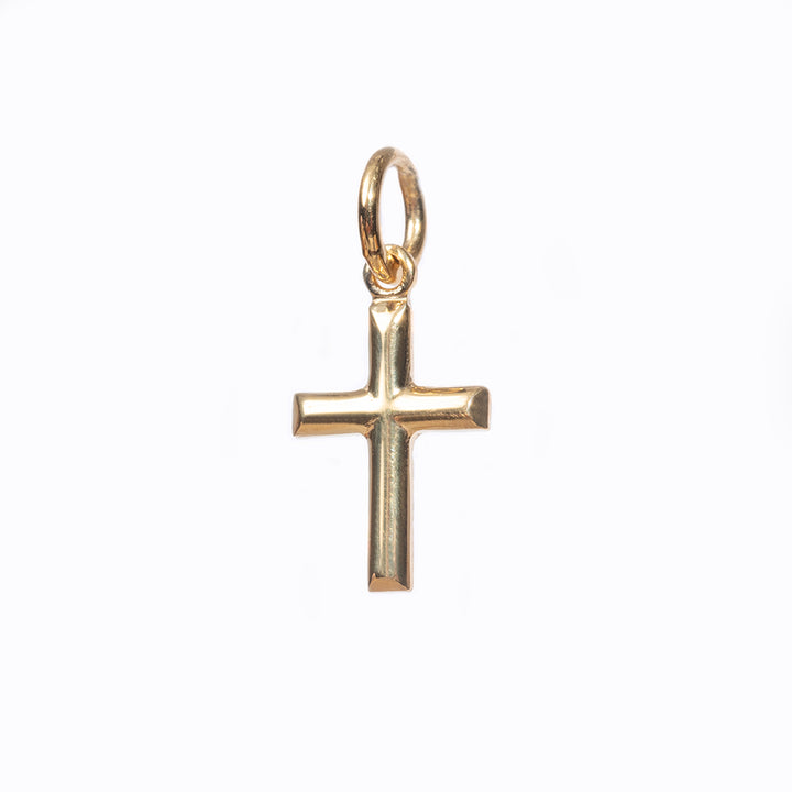 A profile view of Gold Embossed Cross Pendant. 