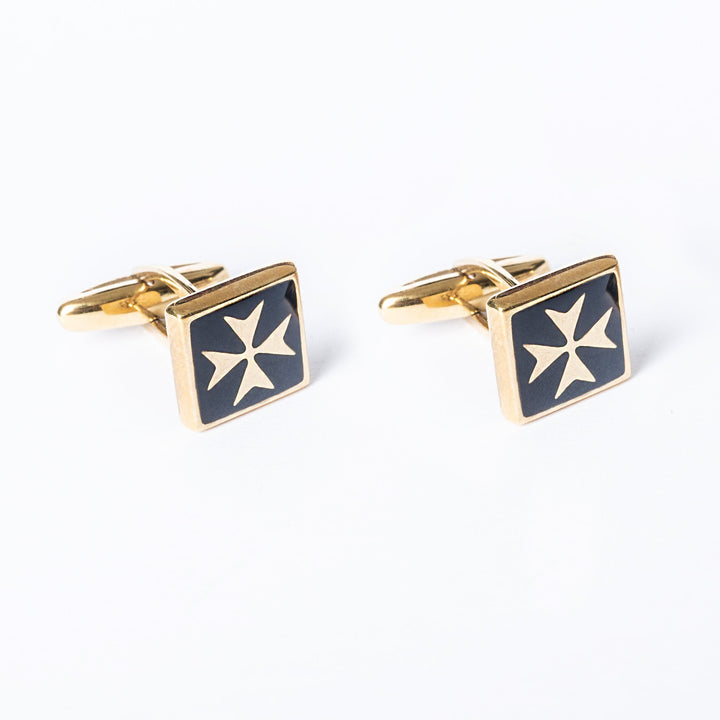 A close up view of Gianni Gold cufflinks standing in the center of the image against a white background. 
