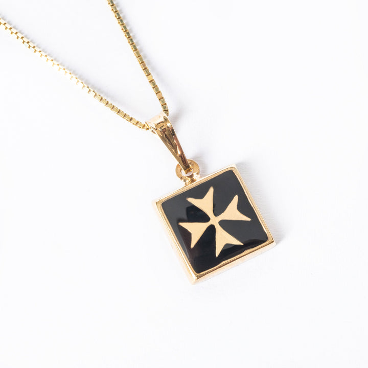 A close up view of  Gianni Gold pendant standing in the center of the image against a white background. 