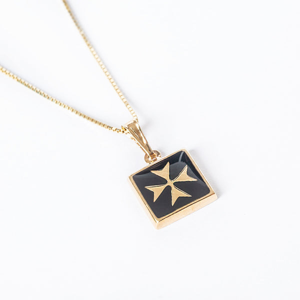 A Gianni gold-plated silver pendant with a black enamel cross on a chain.