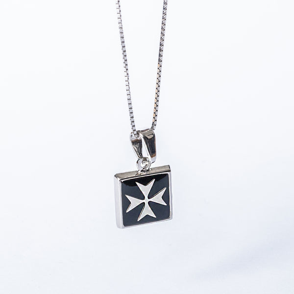 A silver Gianni pendant with a black enamel Maltese cross on a chain against a white background.