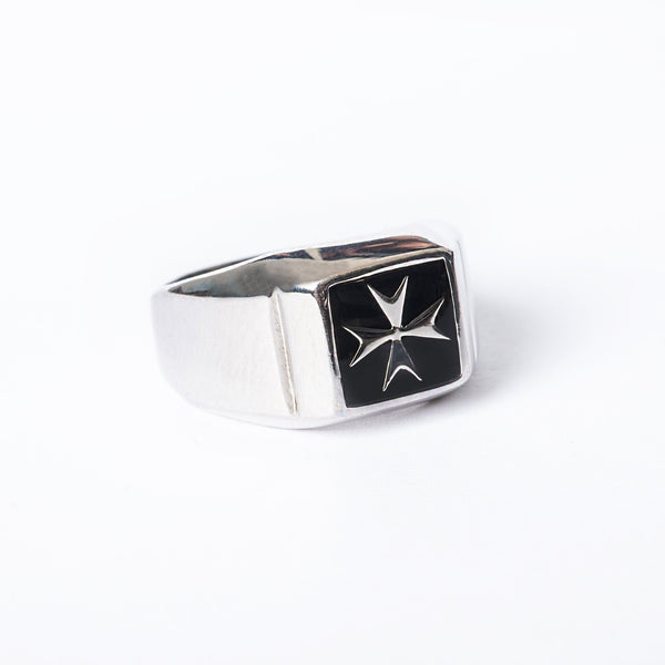 Gianni silver ring with a black enamel Maltese cross emblem on it.
