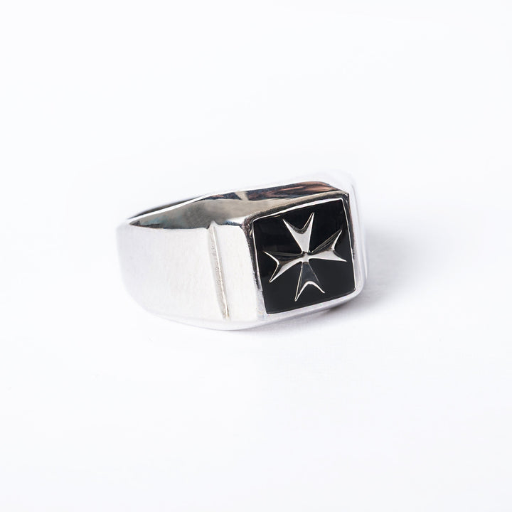 Gianni silver ring with a black enamel Maltese cross emblem on it.