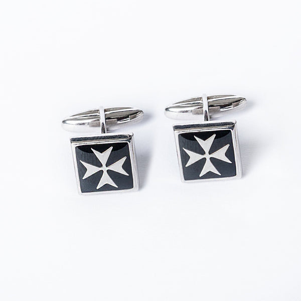 A pair of silver cufflinks with a black enamel Maltese cross design on a white background.
