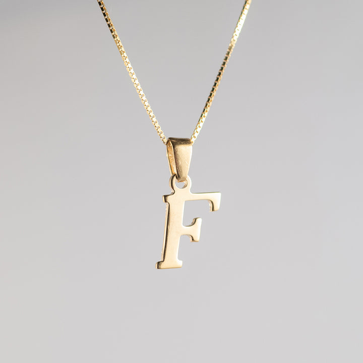 Close up view of initials gold letter pendant F letter 