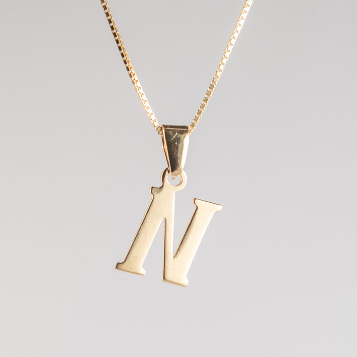 Close up view of initials gold letter pendant N letter 