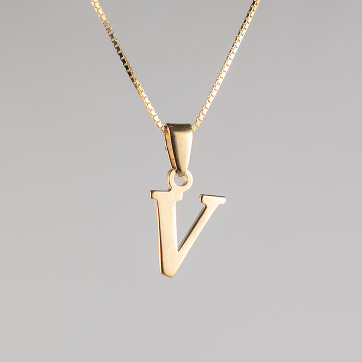 A close up view of initials gold letter pendant letter  