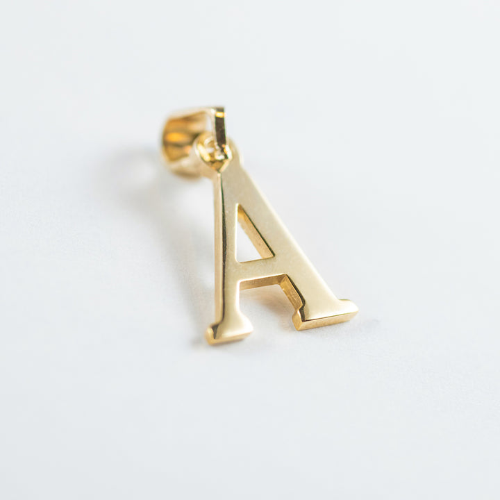 A close up view of initials gold letter pendant A letter  