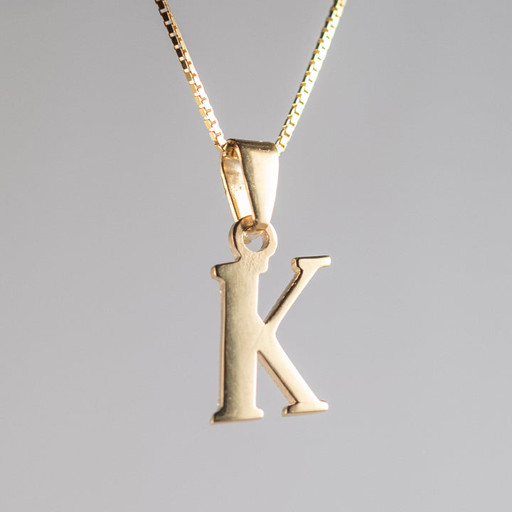 A close up view of initials gold letter pendant k letter 