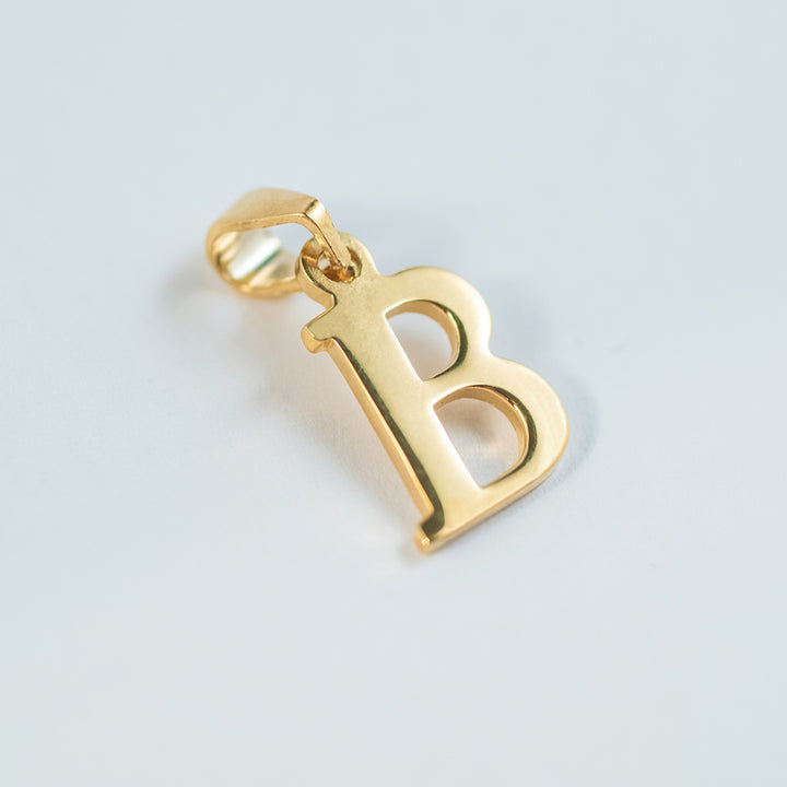 a close up view of initials gold letter pendant B letter 