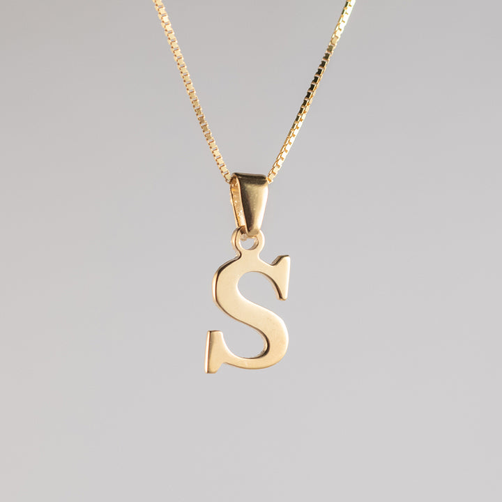 A close up view of initials gold letter pendant letter 