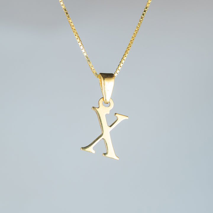 A close up view of initials gold letter pendant x letter 