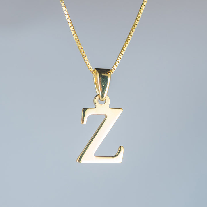 A close up view of initials gold letter pendant Z letter 