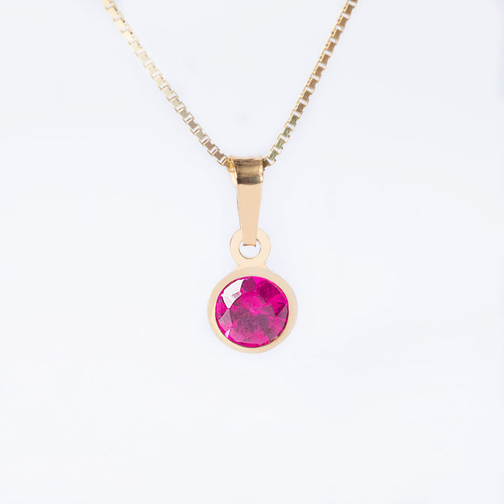 A yellow gold-platedJuly  Birth Stone pendant  with a red ruby-colored gemstone in the center, attached to a gold-plated chain.