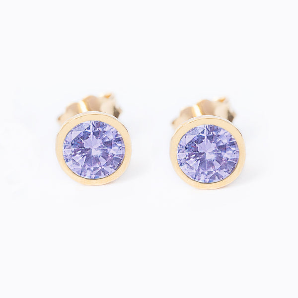 A pair of round June Birth Stone earrings with a yellow gold plated finish and a central amethyst lilac gemstone.